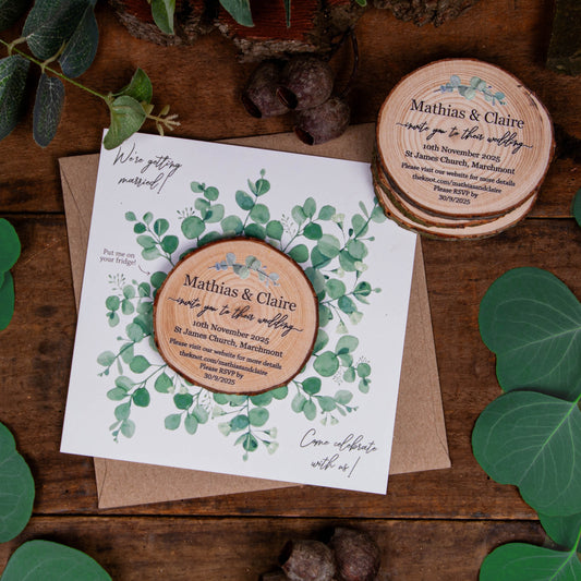 Rustic Eucalyptus-style wedding invitation featuring a wood slice with eucalyptus design and matching card.