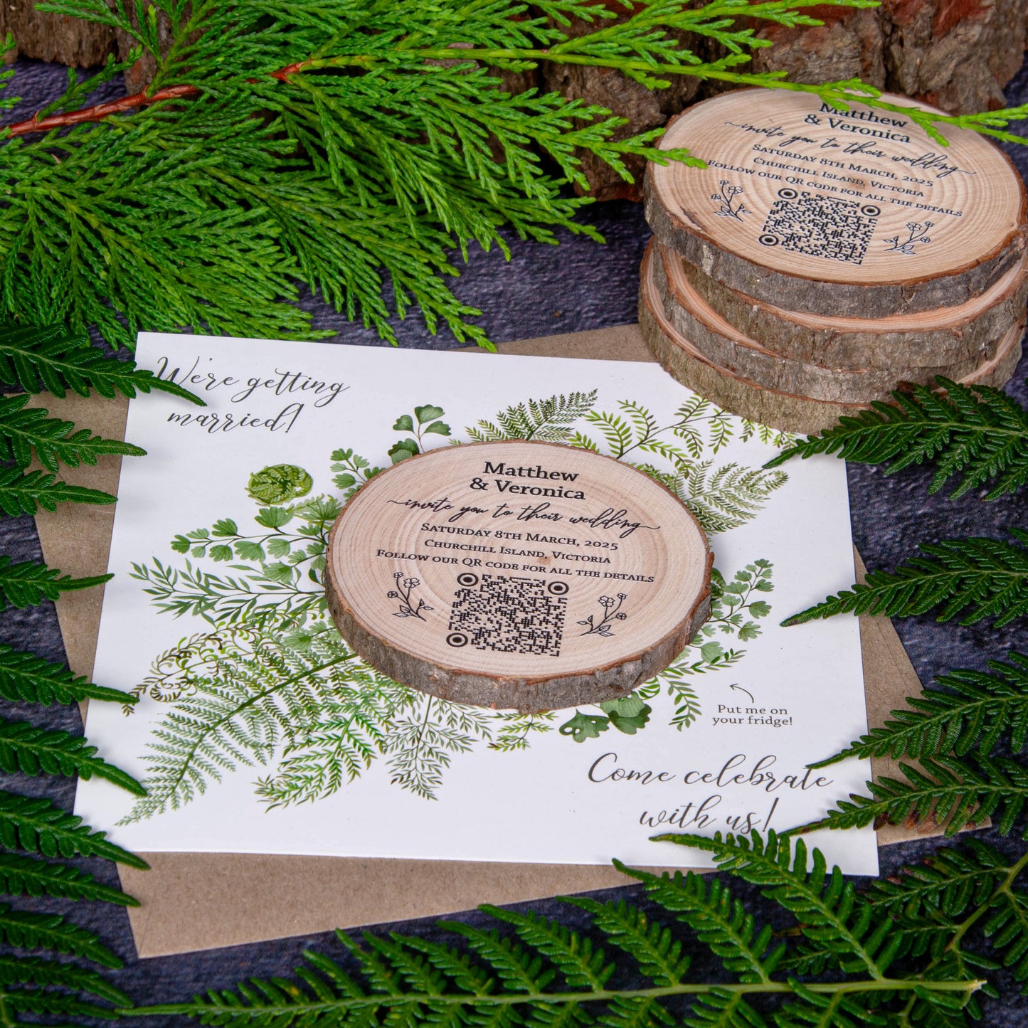 Wedding invitation featuring a wood slice with personalised details on a card with a fern design