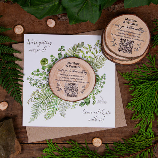 Rustic wedding invite featuring a custom design on a wood slice with a fern card