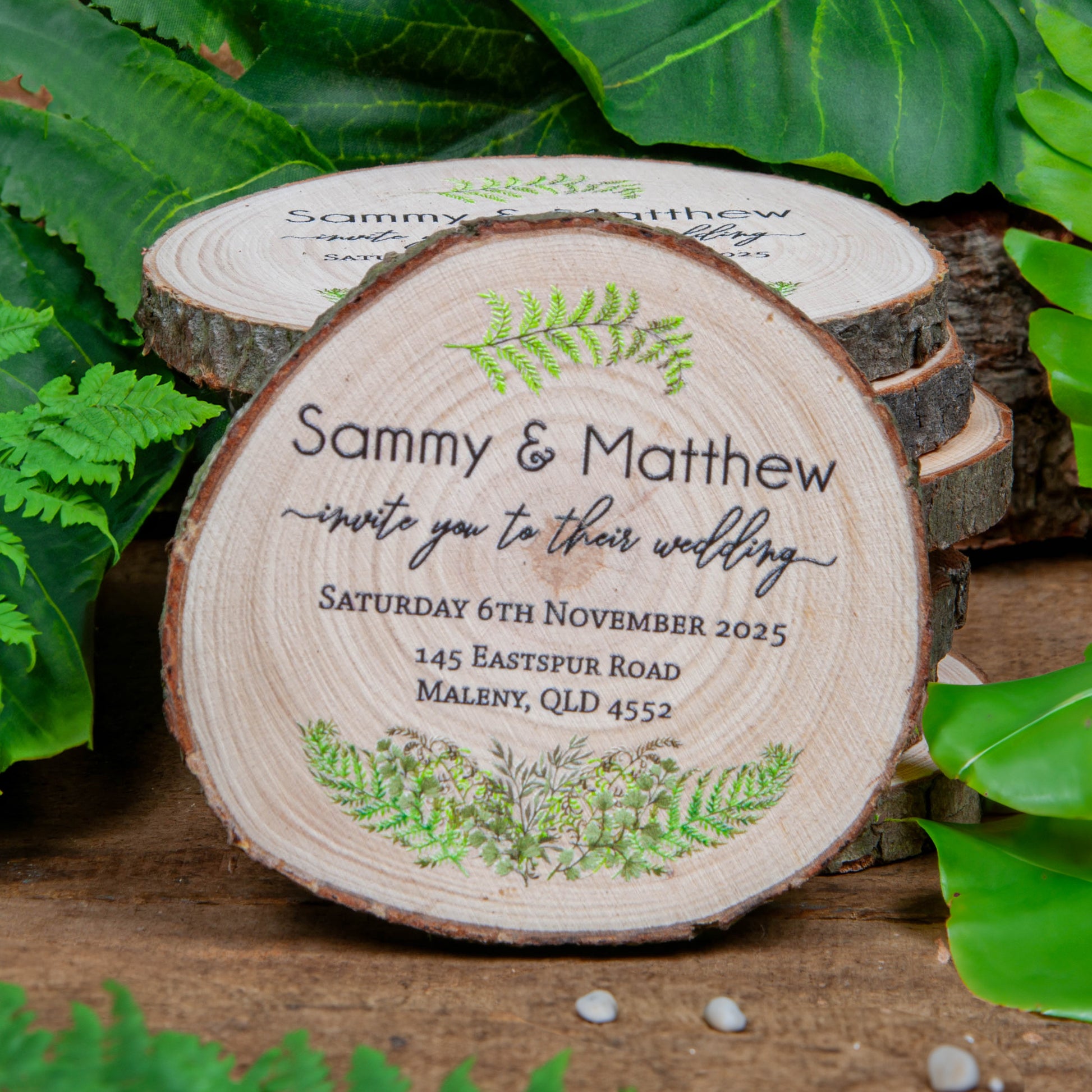 Wedding invite with fern design on wood slice