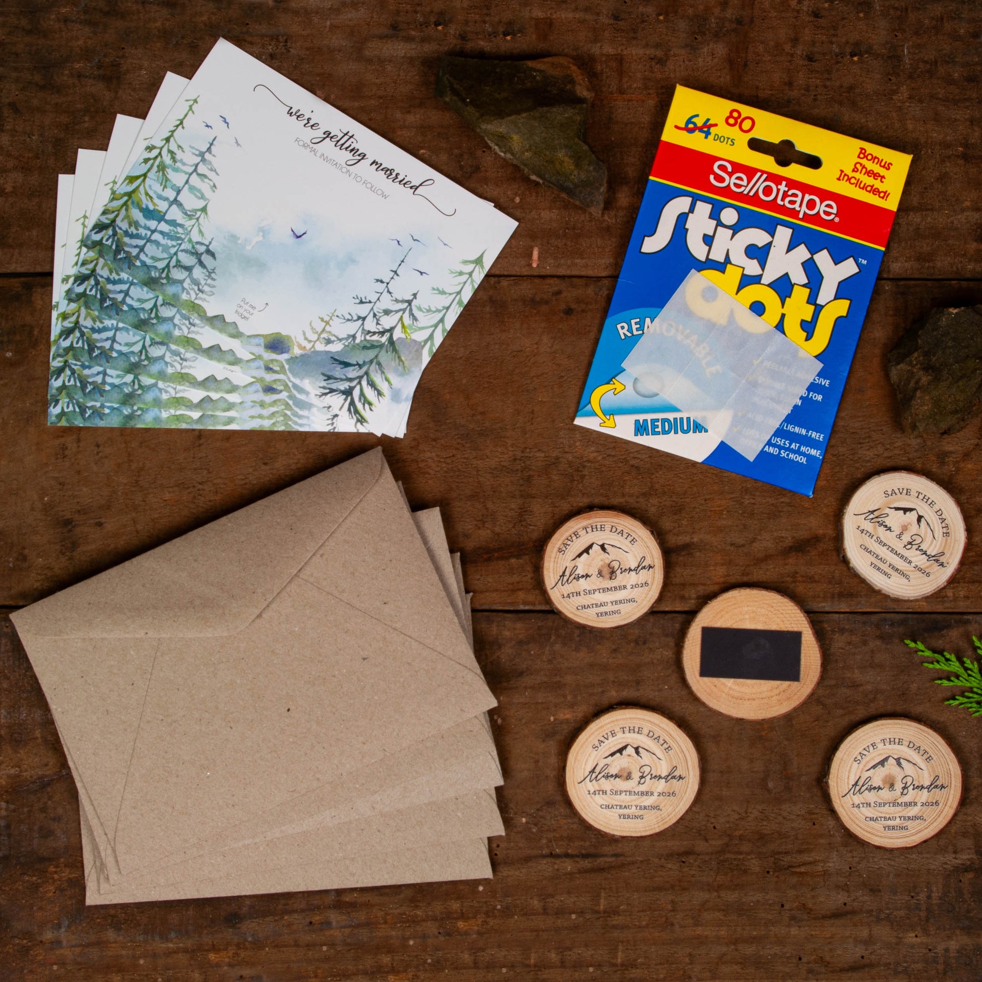 Flatlay of Wedding Forest save the dates with mountain customisation