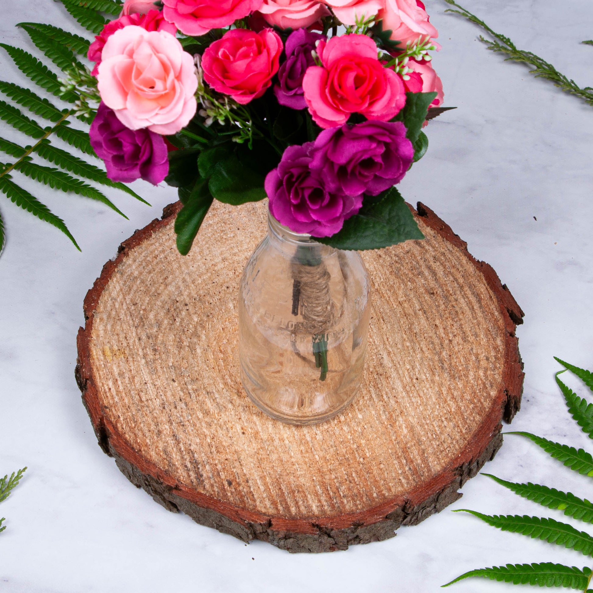 Wood slice centerpiece base with flowers in vase